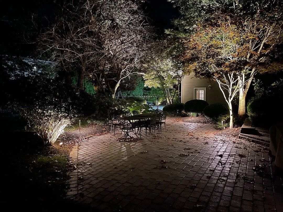 Backyard outdoor living space lit at night